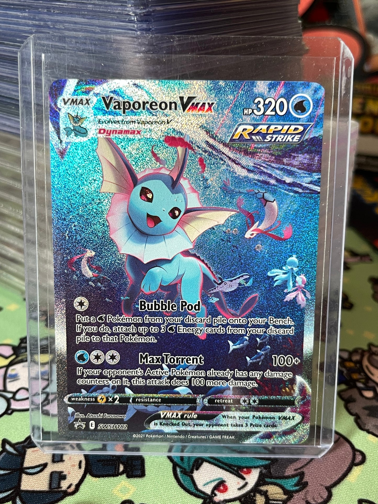 Vaporeon VMAX trading card in a clear protective case on a colorful background
